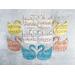 Swan paper shapes in pastel colors with sheet music pattern.
